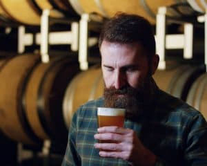 Craft brewer tasting his bourbon barrel beer